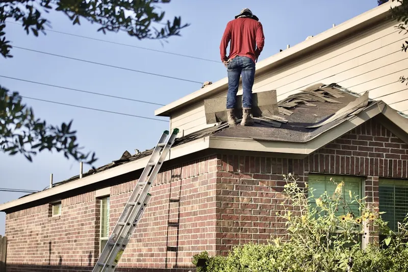 Professional roofer working on a residential roof in Deerfield Village